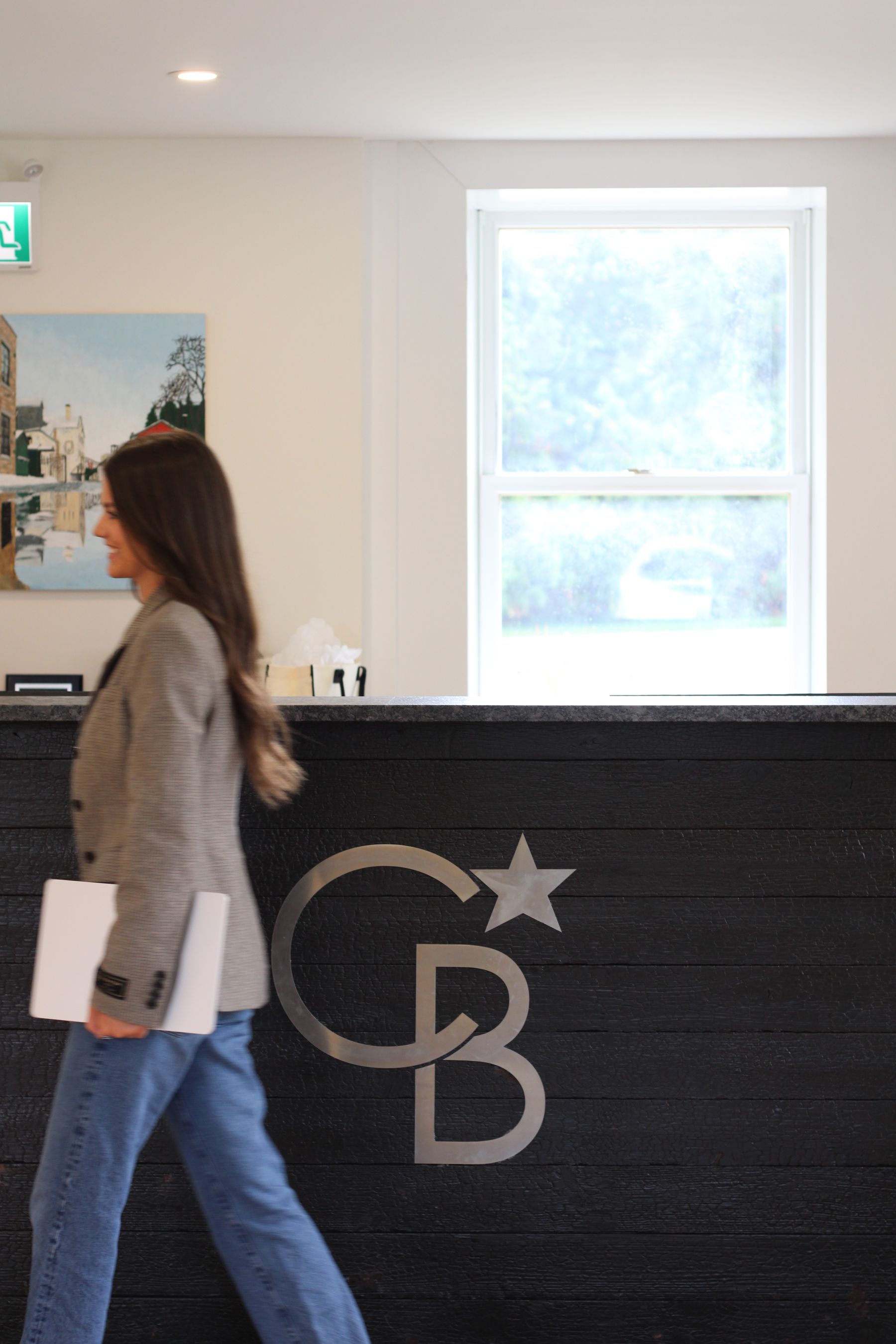 Alexa Keys at the Coldwell Banker Neumann reception desk