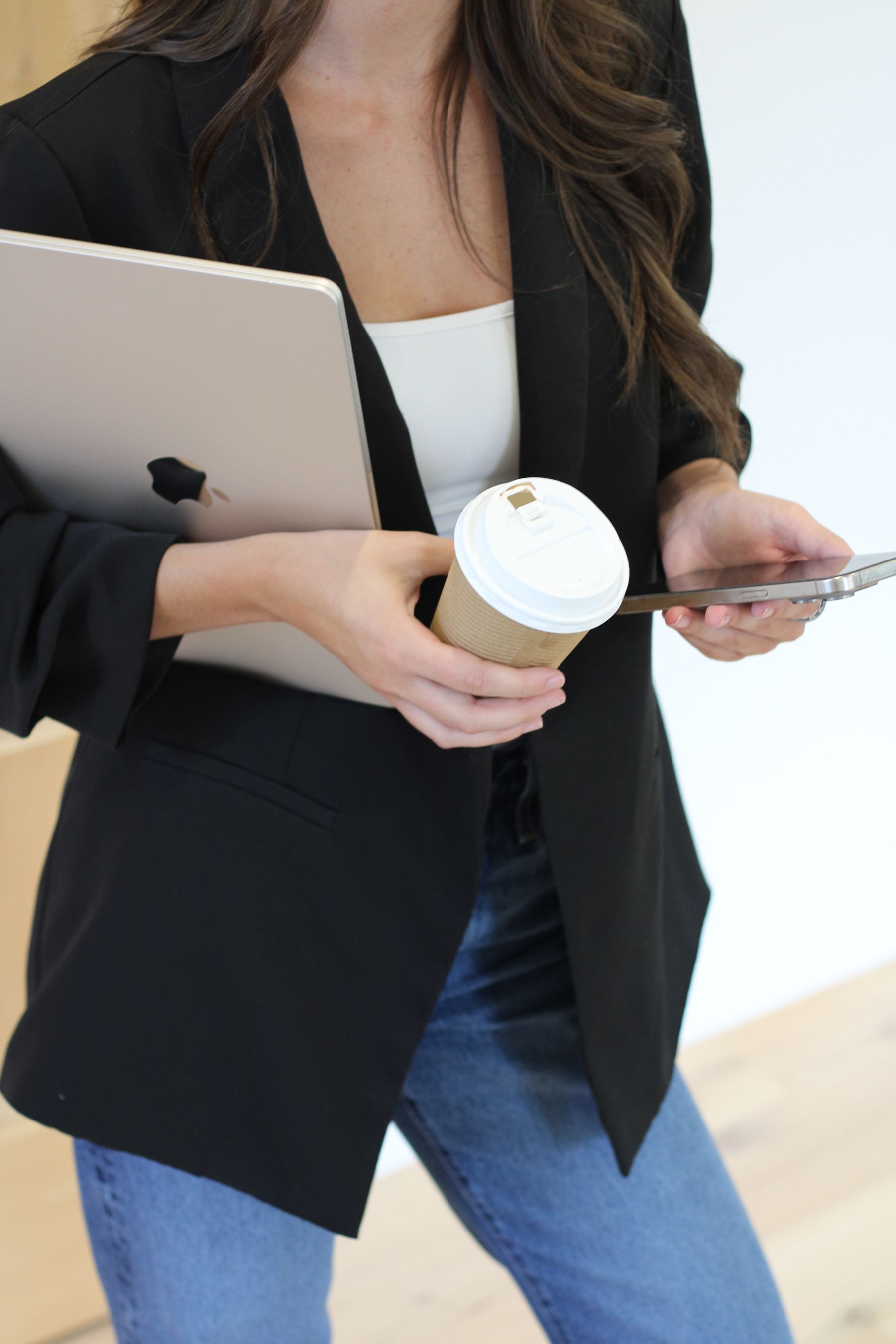 Alexa Keys heading out between appointments with a laptop and coffee